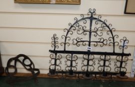 A 17th century wrought iron wall sconce, an iron guard and a wrought iron roasting hanger