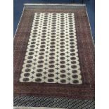 A Bokhara style ivory ground carpet 350 x 240cm