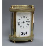 An oval brass carriage timepiece