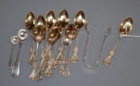 A set of twelve sterling coffee spoons, two silver condiment spoons and a pair of silver sugar