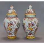 A pair of 19th century French faience vases and covers height 29cm