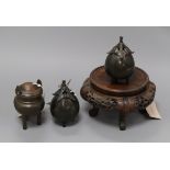 Three bronze koros and covers and a Chinese carved hardwood stand