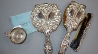 An American Art Nouveau sterling three piece dressing table set and a Tiffany & Co sterling taste