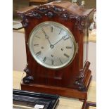 A Victorian mahogany repeating bracket clock having silvered Roman dial, striking and chiming on