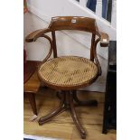 A bentwood and canework swivel desk chair