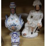A French faience pilgrim flask, a delft figure, a Staffordshire figure and Victorian chamberpot