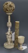 A Chinese carved ivory concentric ball on stand supported by a Buddha with lotus and two other ivory