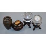 A pair of Chinese crystal spheres on hardwood stands, a hardstone vase, a hardstone 'nest' with eggs