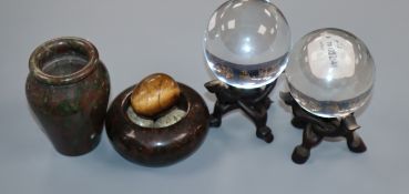 A pair of Chinese crystal spheres on hardwood stands, a hardstone vase, a hardstone 'nest' with eggs