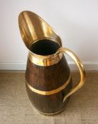 An oak and brass jug stick stand height 66cm