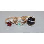 Three assorted 9ct and gem set dress rings.