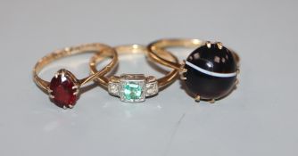 Three assorted 9ct and gem set dress rings.