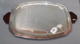 An Art Deco shaped rectangular plated tray with stepped wooden handles length 58cm