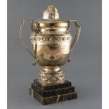 An ornate French silver plated racing two handled trophy cup and cover, inscribed 'Rallye Feminin