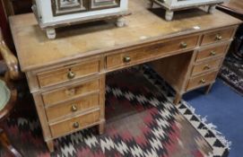 An early 20th century pine pedestal kneehole desk W.152cm