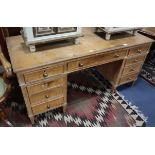 An early 20th century pine pedestal kneehole desk W.152cm