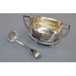 A George V silver sugar bowl and a Victorian silver fiddle pattern sifter spoon.