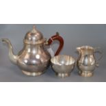 A Queen Anne style silver three-piece tea service, comprising teapot with scrolled wooden handle,