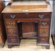 A George III style mahogany kneehole secretaire desk W.82cm