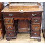 A George III style mahogany kneehole secretaire desk W.82cm
