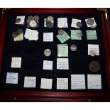 A small collection of Roman and Greek silver and bronze coins, cased with collector's labels (32)