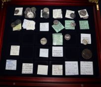 A small collection of Roman and Greek silver and bronze coins, cased with collector's labels (32)