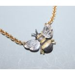 A yellow and white metal 'bee' pendant on 18ct yellow gold chain, gross 11 grams.