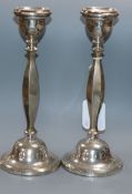 A pair of George V silver candlesticks, Birmingham, 1925, weighted, 24.1cm.