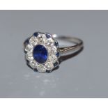 A sapphire and diamond cluster ring, white metal setting, size M.