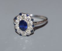 A sapphire and diamond cluster ring, white metal setting, size M.