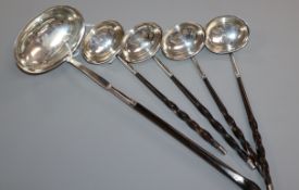 Four George III small silver toddy ladles with whalebone handles and a similar larger ladle (