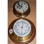 A ship's aneroid barometer and a bulkhead clock