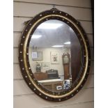 A 19th century oval Irish paste mounted mirror H.62cm