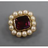An early Victorian yellow metal, foil backed garnet and split pearl brooch, 22mm.