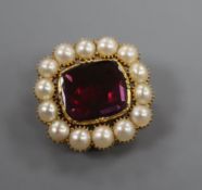 An early Victorian yellow metal, foil backed garnet and split pearl brooch, 22mm.