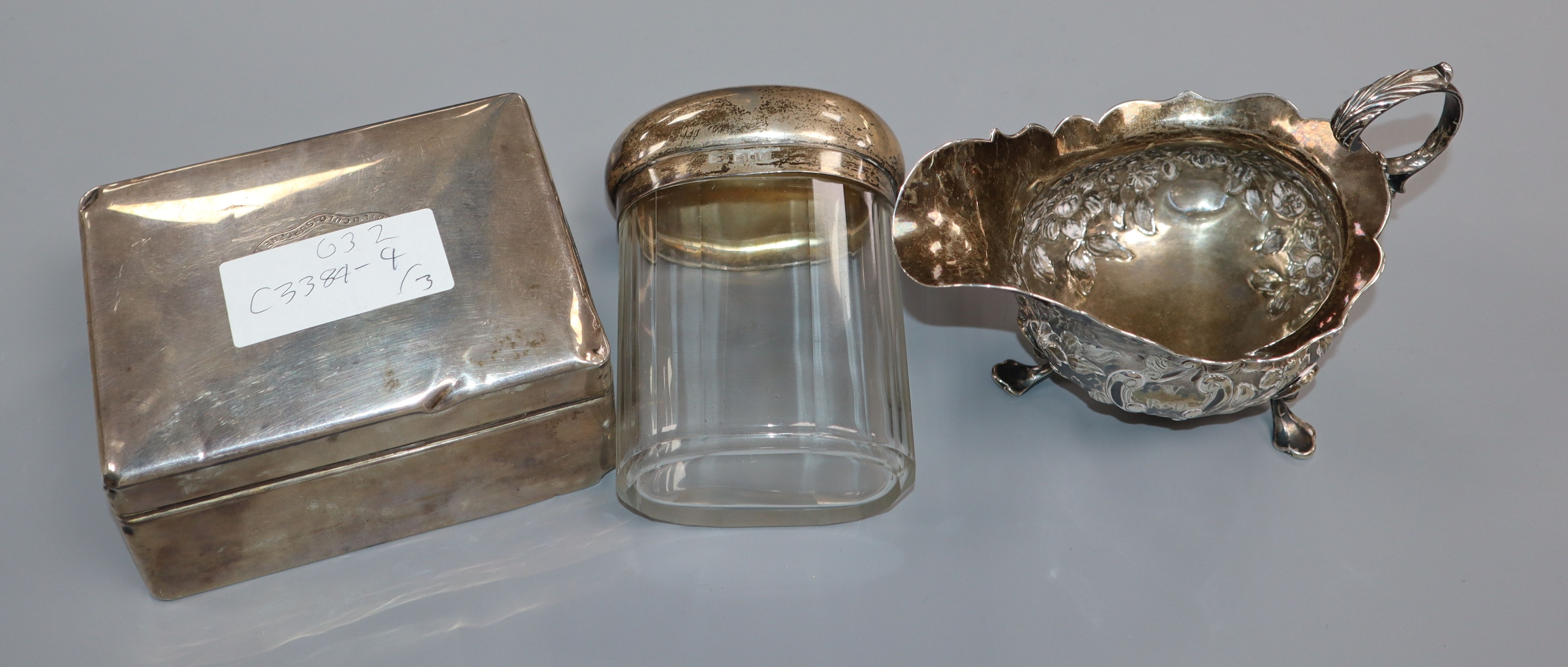 A George III silver sauce boat, a silver cigarette box and silver mounted glass toilet bottle. - Image 2 of 2