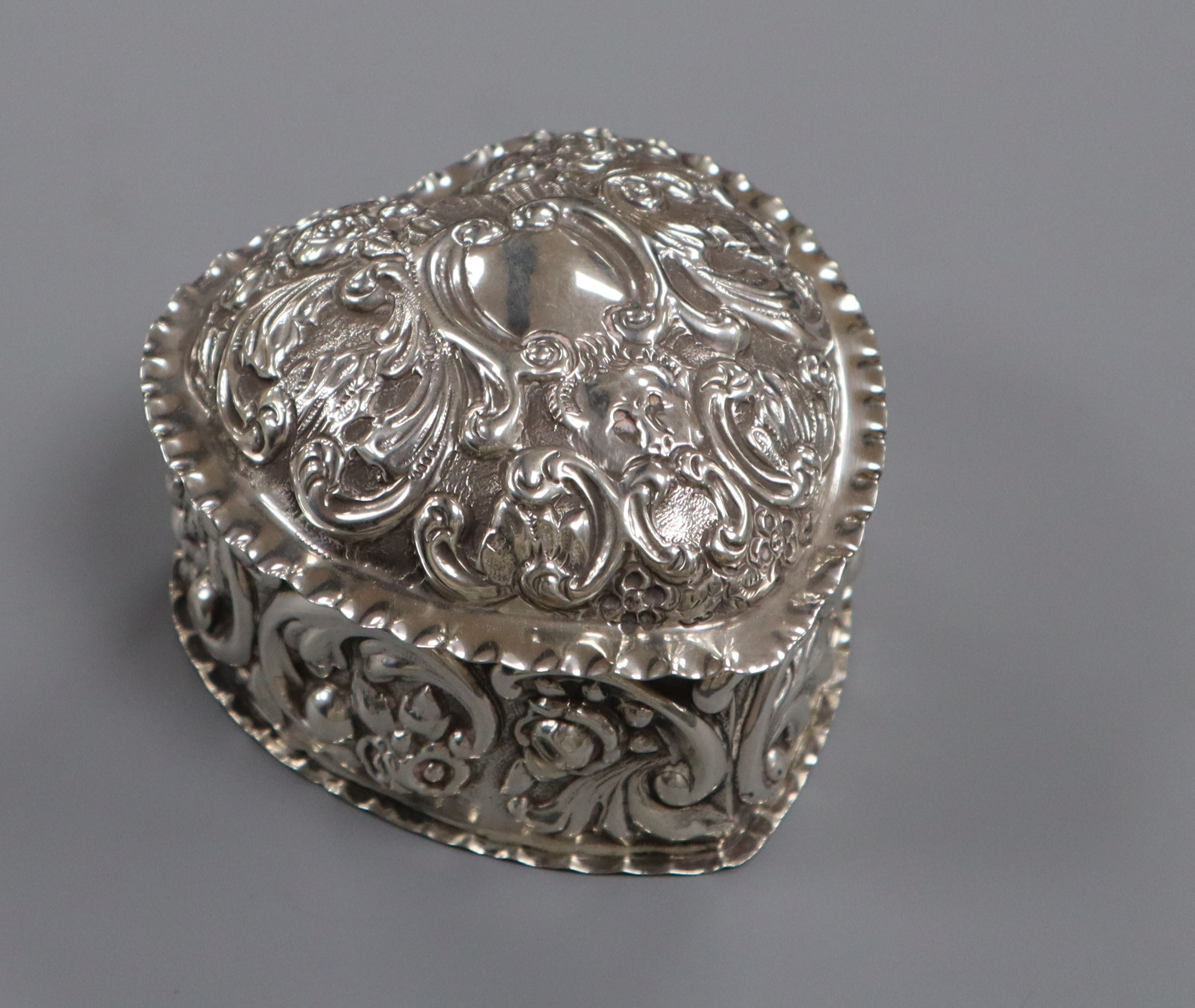 A late Victorian repousse silver heart shaped trinket box, William Hutton & Sons Ltd, London,
