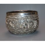 A late 19th/early 20th century Burmese white metal small bowl embossed with animals, diameter approx