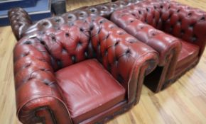 Two leather oxblood leather chesterfield armchairs W.106cm