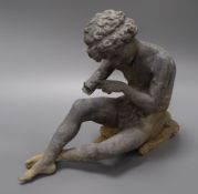 A garden figure of a seated boy height 27cm