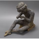 A garden figure of a seated boy height 27cm