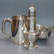 A modern silver mug, a George V silver sugar caster and similar sauce boat, 17.5 oz.