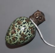 A Victorian novelty ceramic scent flask in the form of an egg with screw-on white metal top modelled