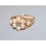 A late Victorian yellow metal, split pearl and emerald cluster dress ring, size K/L.