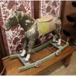 A painted wooden pull-along rocking horse L.90cm