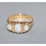 A George V 18ct gold, three stone opal and diamond chip set dress ring, size O.
