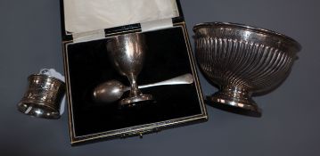 A late Victorian silver christening bowl, a cased egg cup and spoon set and a napkin ring.