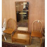 An Ercol elm cheval mirror and two Ercol comb back chairs