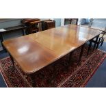 A mahogany extending dining table circa 1830's, centre section with drop leaves 252cm extended