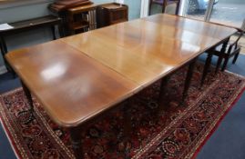 A mahogany extending dining table circa 1830's, centre section with drop leaves 252cm extended